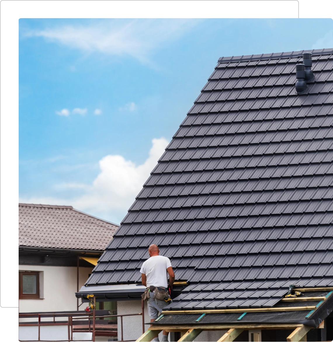 Man repairing house roof tiles